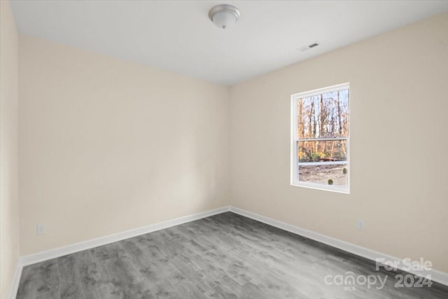 empty room with hardwood / wood-style flooring