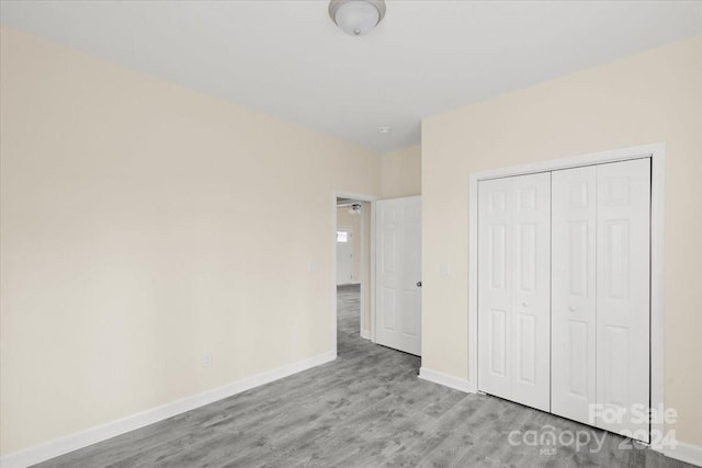 unfurnished bedroom featuring a closet and light hardwood / wood-style flooring