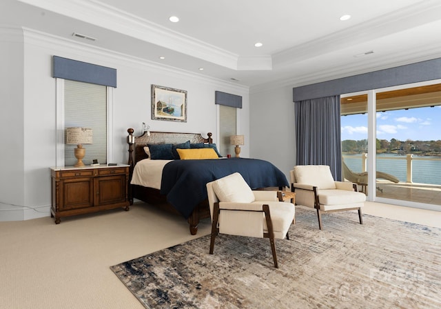 bedroom featuring access to exterior, crown molding, light colored carpet, a tray ceiling, and a water view