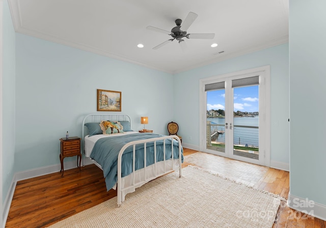 bedroom with access to exterior, ornamental molding, ceiling fan, a water view, and light hardwood / wood-style floors