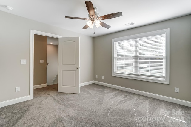 unfurnished bedroom with ceiling fan and light carpet