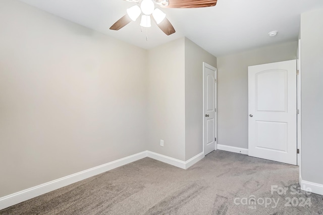 empty room featuring light carpet and ceiling fan