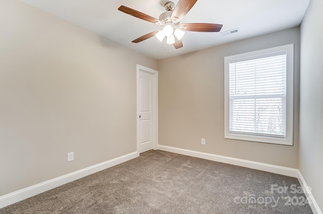 spare room with carpet and ceiling fan