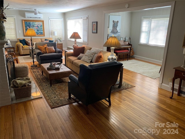 living room featuring hardwood / wood-style floors and a wall mounted AC