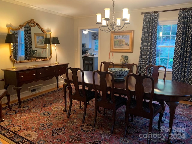 dining area with a notable chandelier and ornamental molding