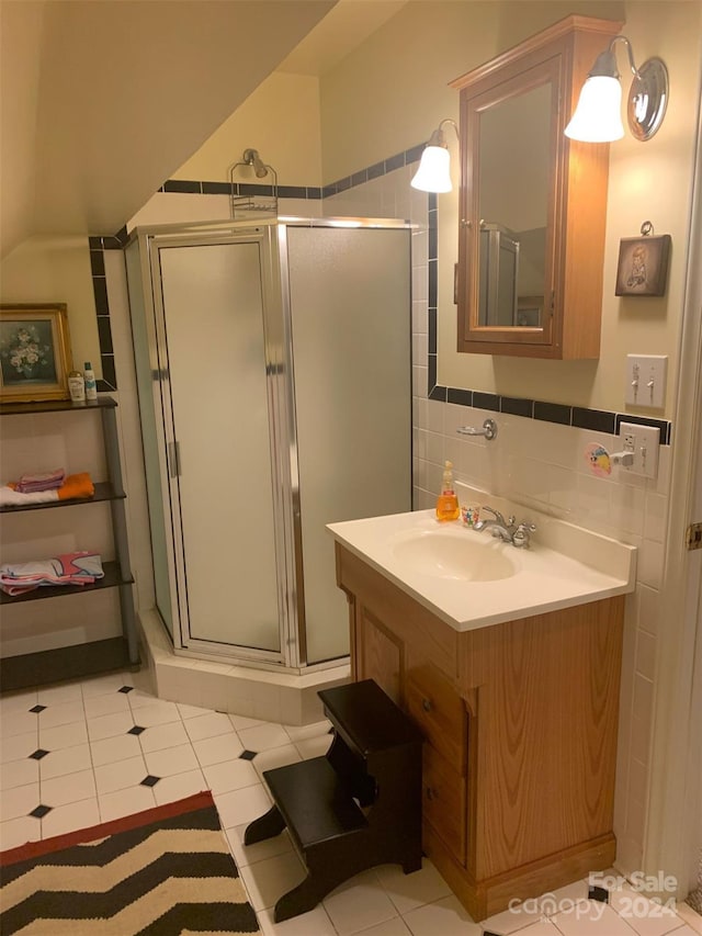 bathroom featuring decorative backsplash, tile patterned flooring, vanity, and a shower with shower door