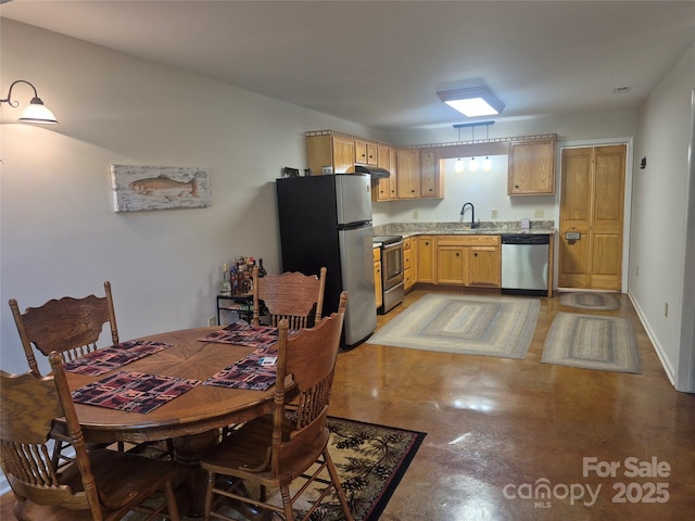 369 Pinecrest Cir, Troy, NC 27371 - kitchen featuring stainless steel appliances, under cabinet range hood, finished concrete floors, light countertops, and light brown cabinetry