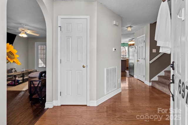 interior space with a wealth of natural light, hardwood / wood-style floors, and a textured ceiling