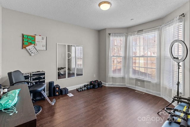 office space with dark wood-type flooring and a textured ceiling