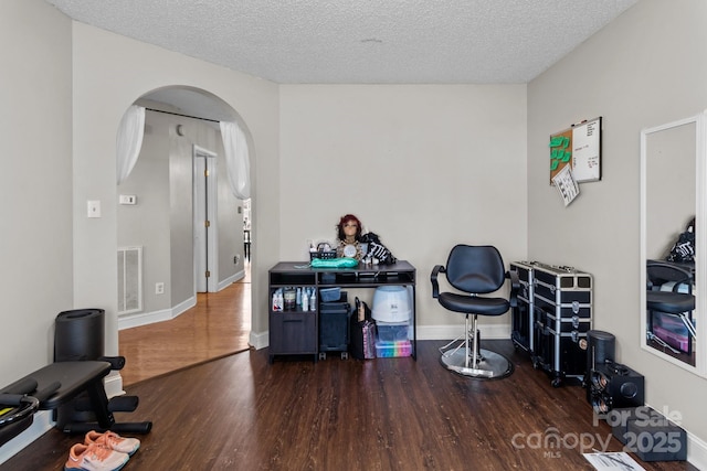 misc room with dark hardwood / wood-style flooring and a textured ceiling