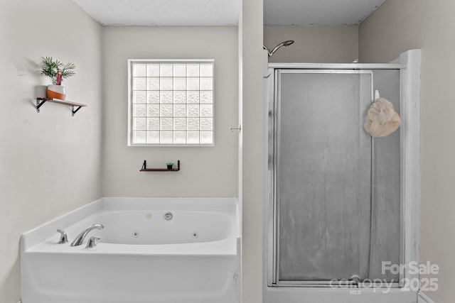 bathroom with shower with separate bathtub and a textured ceiling