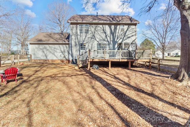 rear view of property featuring a deck