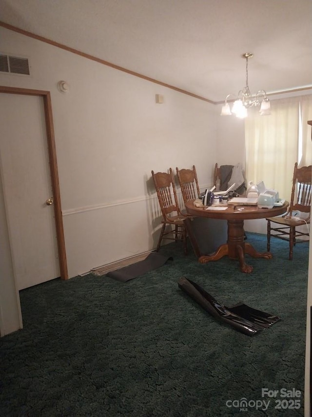 carpeted dining room with ornamental molding and an inviting chandelier