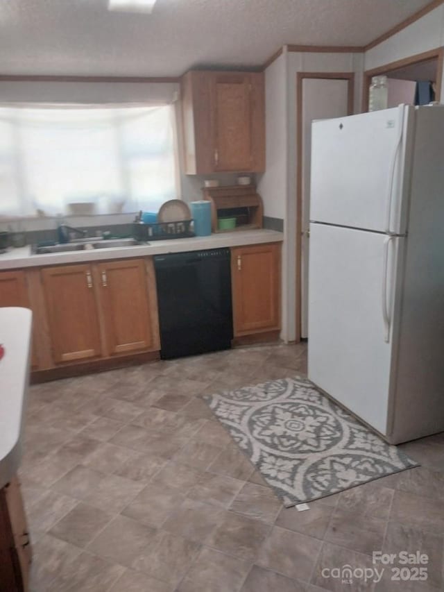 kitchen featuring sink, a textured ceiling, ornamental molding, black dishwasher, and white fridge