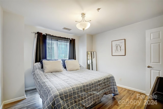 bedroom with hardwood / wood-style floors