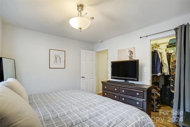 bedroom featuring a walk in closet and a closet