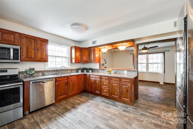 kitchen featuring a healthy amount of sunlight, sink, stainless steel appliances, and light hardwood / wood-style floors