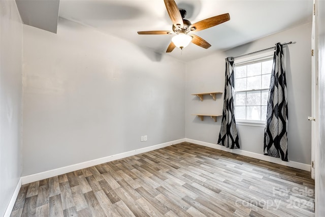 spare room featuring light wood-type flooring and ceiling fan