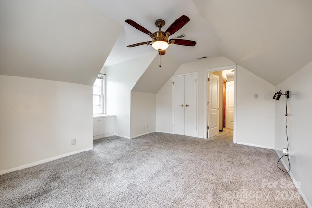 additional living space featuring ceiling fan, light carpet, and vaulted ceiling