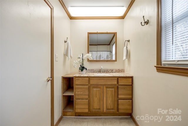 bathroom with tile patterned floors, vanity, and ornamental molding