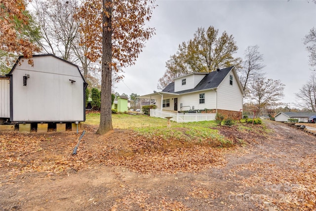 exterior space with covered porch and an outbuilding