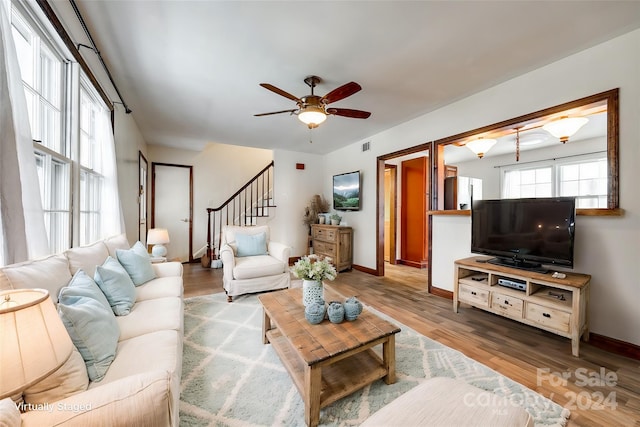 living room featuring hardwood / wood-style floors and ceiling fan