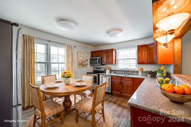 kitchen featuring dark hardwood / wood-style flooring, sink, and appliances with stainless steel finishes