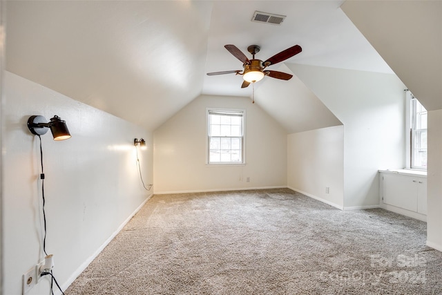 bonus room with light carpet, ceiling fan, and lofted ceiling