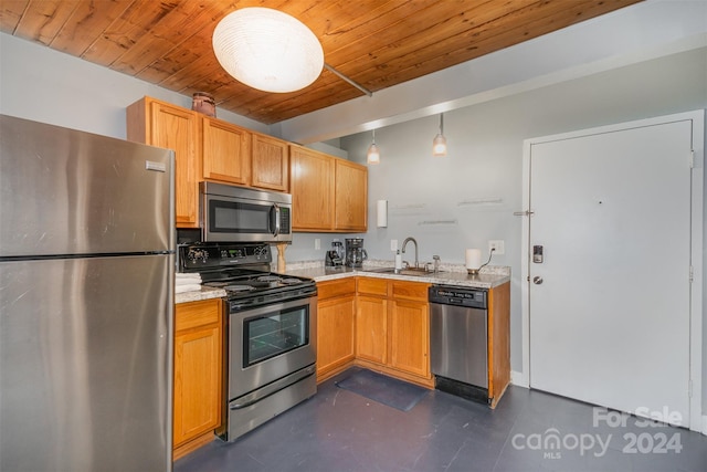 kitchen featuring wood ceiling, pendant lighting, sink, and stainless steel appliances