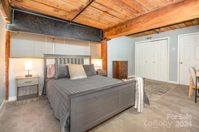 carpeted bedroom featuring wood ceiling and a closet