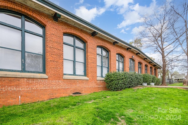 view of side of home featuring a lawn