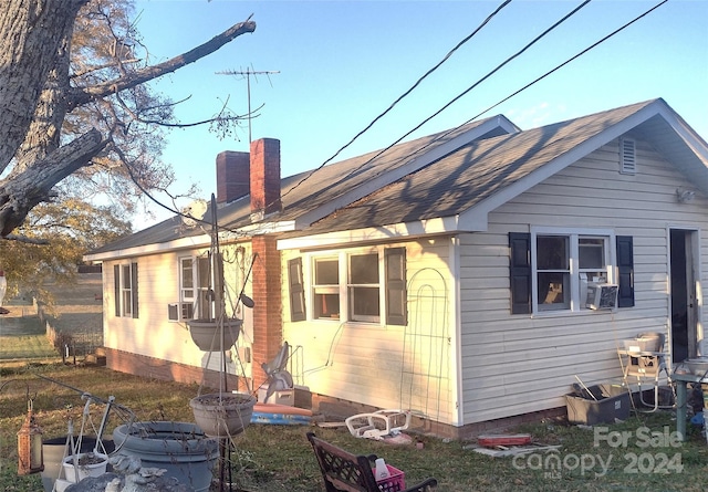 back of house featuring cooling unit