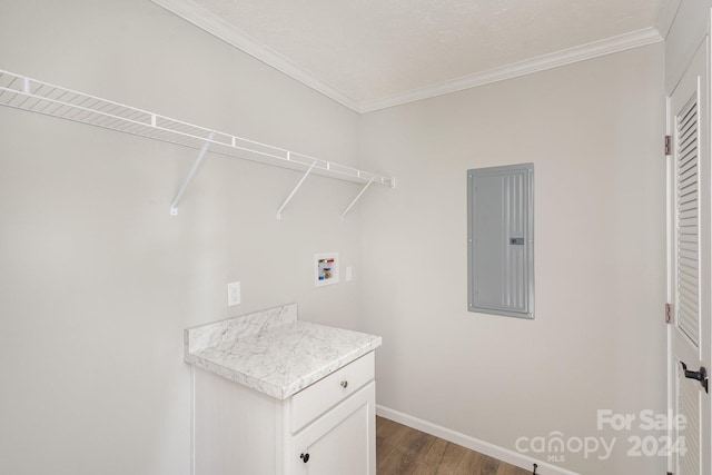 washroom with hardwood / wood-style floors, hookup for a washing machine, crown molding, and electric panel