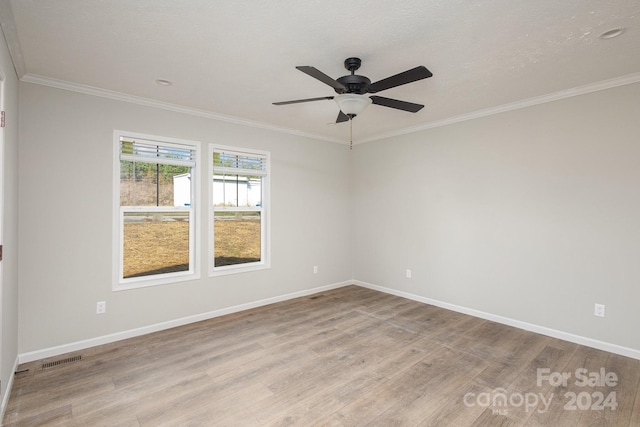 spare room with light wood-type flooring, ceiling fan, and crown molding