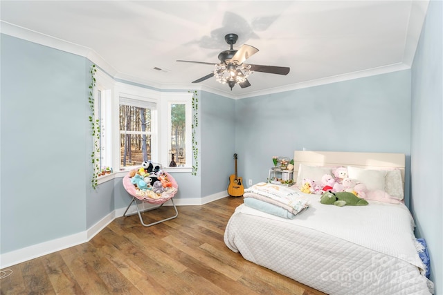 bedroom with hardwood / wood-style flooring, ceiling fan, and ornamental molding