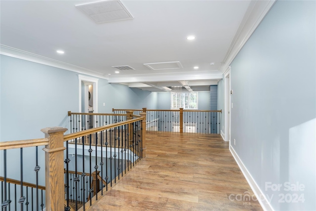 corridor featuring ornamental molding and light hardwood / wood-style flooring