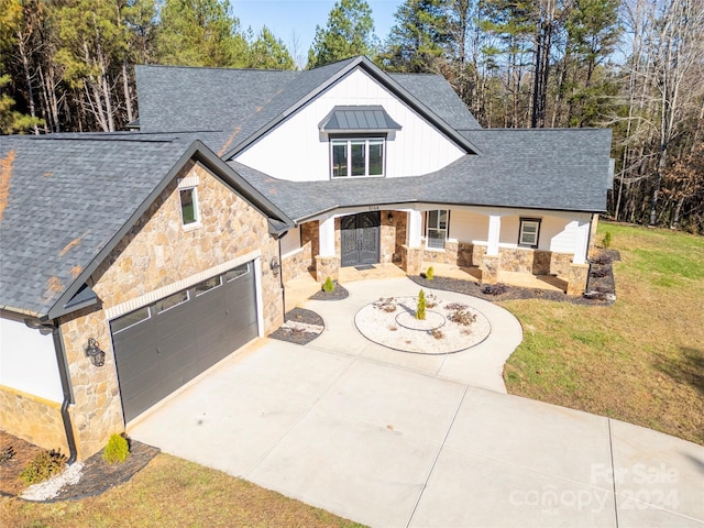 view of front of house featuring a garage and a front lawn