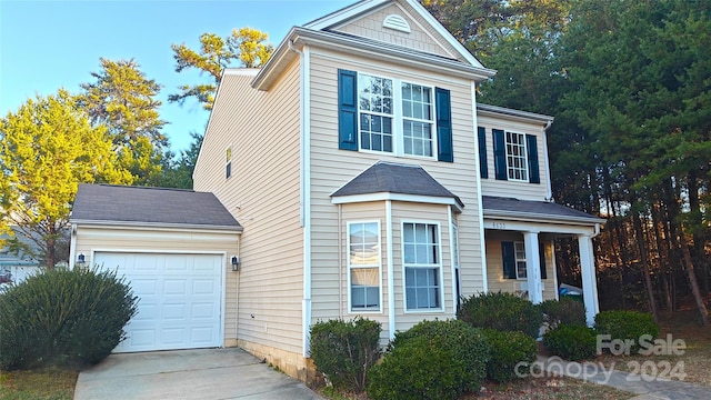 front of property featuring a porch and a garage