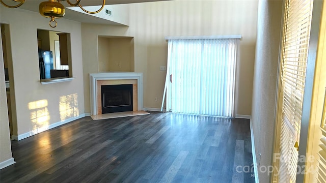 unfurnished living room with dark wood-type flooring