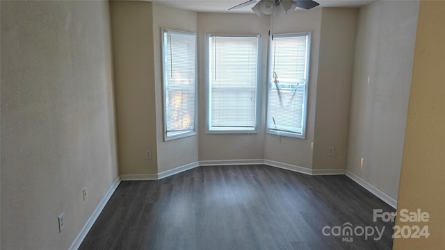 unfurnished room with ceiling fan and dark wood-type flooring