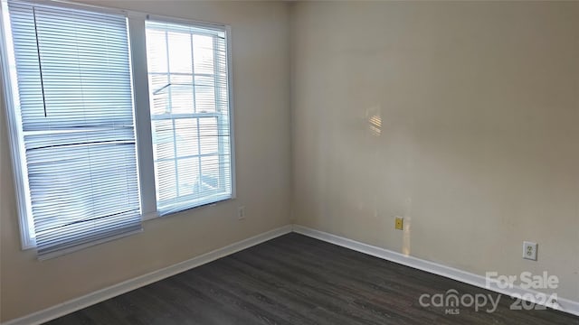 empty room with dark wood-type flooring