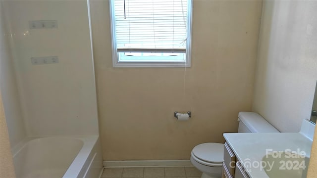 bathroom featuring tile patterned flooring, vanity, a bathtub, and toilet