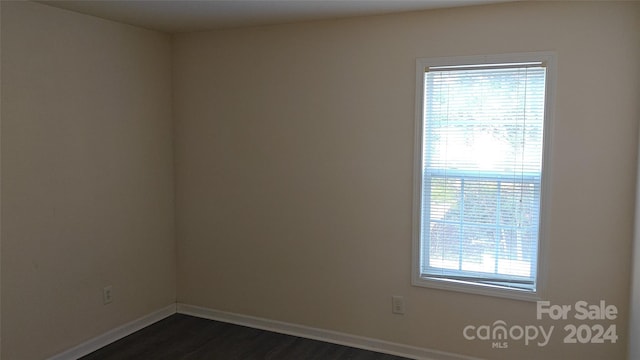 spare room with dark hardwood / wood-style flooring