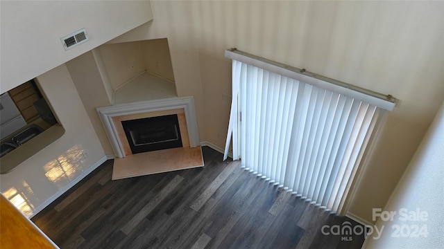 unfurnished living room featuring dark hardwood / wood-style floors and high vaulted ceiling