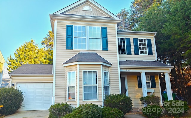 view of front of house with a porch and a garage