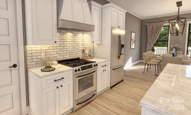 kitchen featuring white cabinetry, hanging light fixtures, light hardwood / wood-style floors, custom exhaust hood, and appliances with stainless steel finishes