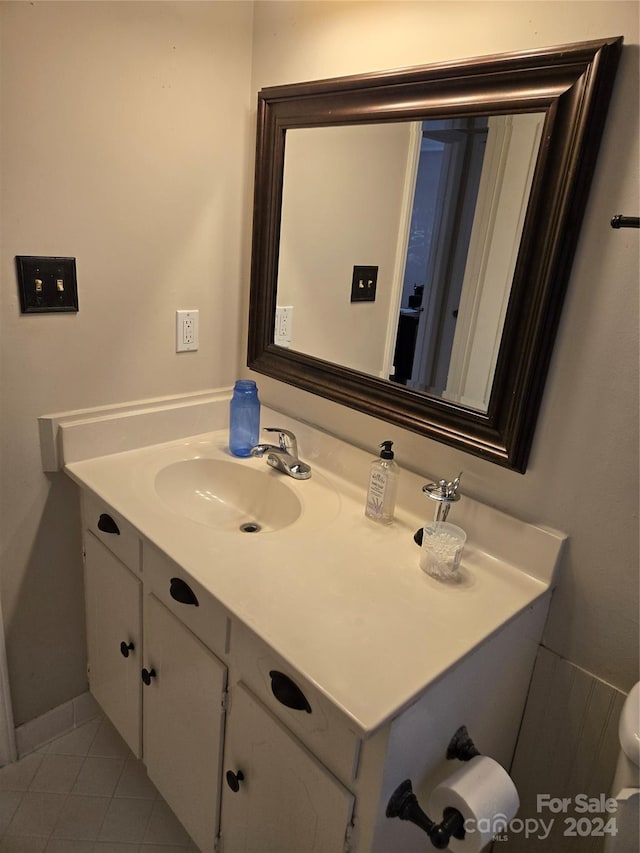 bathroom with tile patterned floors and vanity