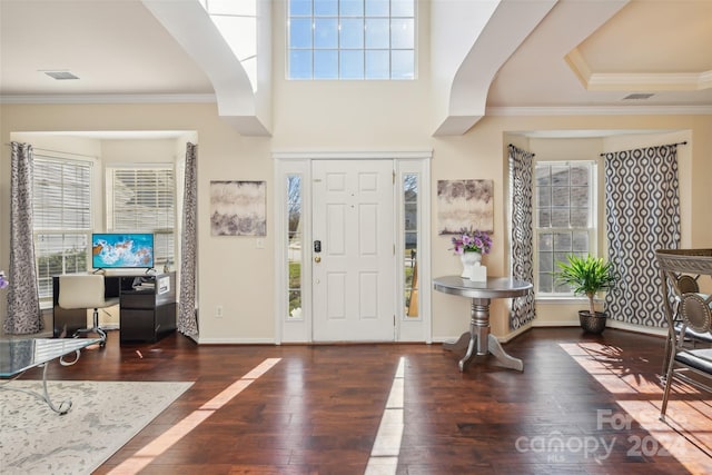 foyer featuring dark hardwood / wood-style flooring and crown molding