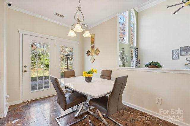 dining room featuring ceiling fan with notable chandelier and ornamental molding