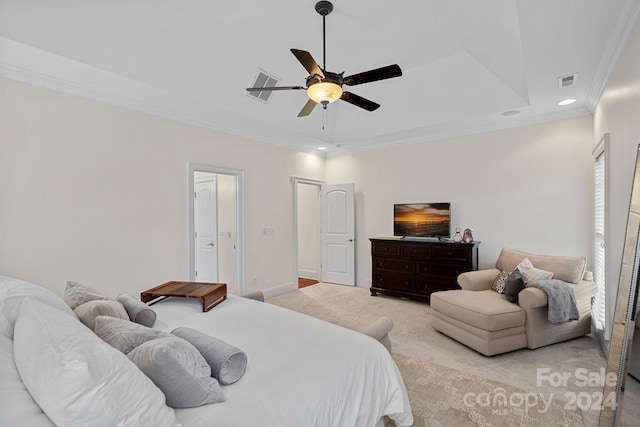 bedroom featuring light carpet, a tray ceiling, ceiling fan, and crown molding